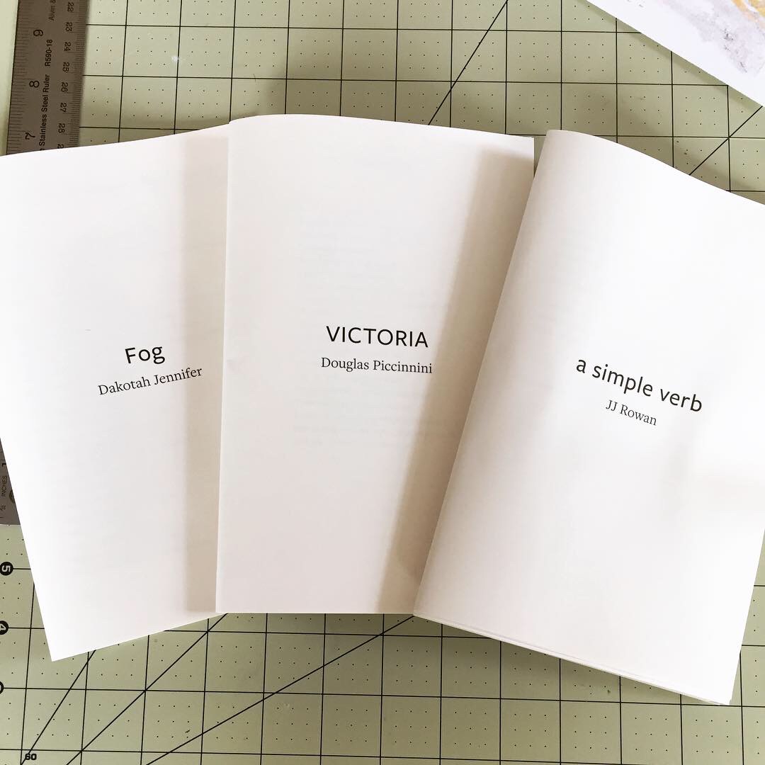 Three folded chapbook interiors, unbound, without covers, black text printed on cream paper. From left to right: Fog by Dakotah Jennifer, Victoria by Douglas Piccinnini, and a simple verb by JJ Rowan.