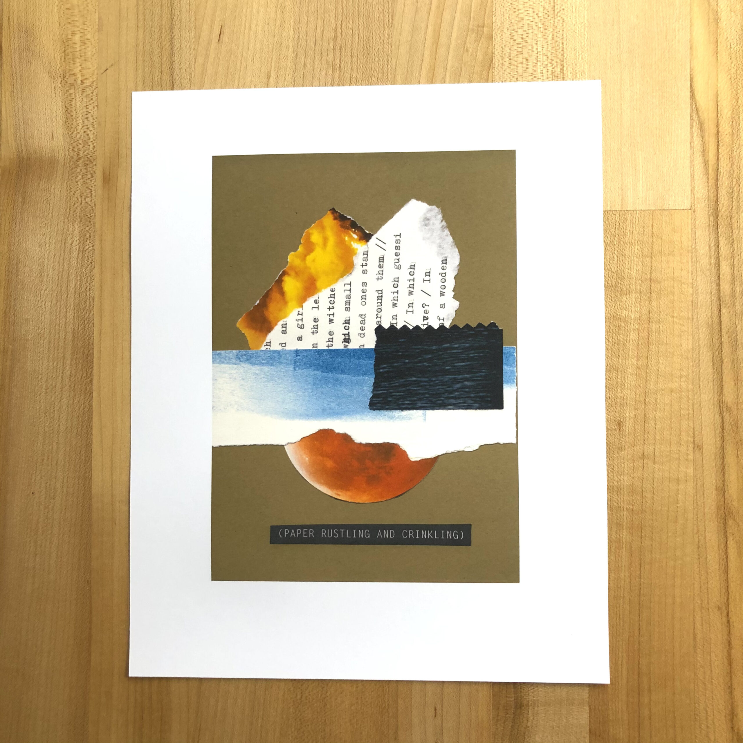 A high-quality ink jet print of an analog collage, lying on a maple tabletop. The collage features torn shapes of fire, typescript, blue ink swipe, dark ocean layered above a red planet. The closed-caption title below says “(PAPER RUSTLING AND CRINKLING).”