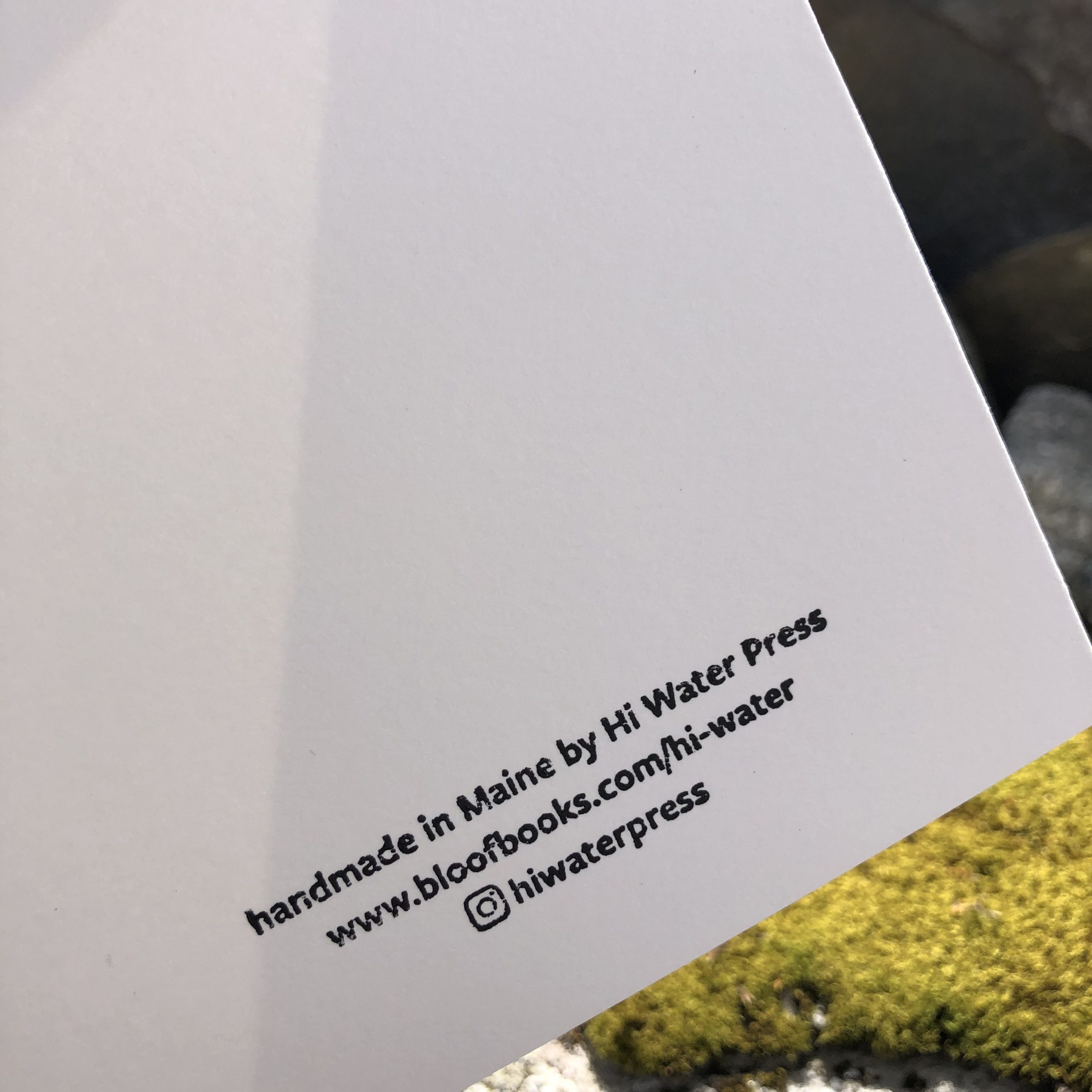 The lower half of the back of the card, which contains small text in black ink: handmade in Maine by Hi Water Press, followed by the press URL and instagram handle.
